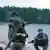 Soldiers with weapons drawn on the coastline of the Estonian island of Hiiumaa