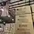 Boxes of humanitarian aid marked USAID in a warehouse with an American flag