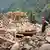 A member of the Afghan Red Crescent searches for victims beneath the rubble after an earthquake struck the provinces of Kunar and Nangarhar near the city of Jalalabad on Monday, September 1, 2025