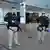 Three armed police officers standing in front of Brazilian Supreme Court building in Brasilia
