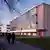 A modernist glass building with letters reading Dessau