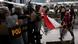 A woman waves an Indonesian flag in the direction of riot police officers, during a clash at a protest against what the demonstrators say are exorbitant allowances for Indonesian parliament members, outside Indonesian parliament buildings, in Jakarta A woman waves an Indonesian flag in the direction of riot police officers, during a clash at a protest against what the demonstrators say are exorbitant allowances for Indonesian parliament members, outside Indonesian parliament buildings, in Jakarta