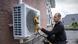 Electrician installing a heat pump Electrician installing a heat pump