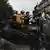 Demonstrators climb on the barricade during a protest against social media bans and corruption