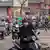 Motorcyclists navigate heavy traffic at intersection in Hanoi, Vietnam, on March 27, 2025