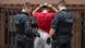 Two German police officers conducting a body search of a male suspect in Frankfurt's notorious Bahnhofviertel. Two German police officers conducting a body search of a male suspect in Frankfurt's notorious Bahnhofviertel.