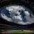 View of the National Stadium, with oval opening in roof giving a view of the sky with clouds