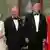 Two pairs of formally dressed people smiling broadly for the camera. 