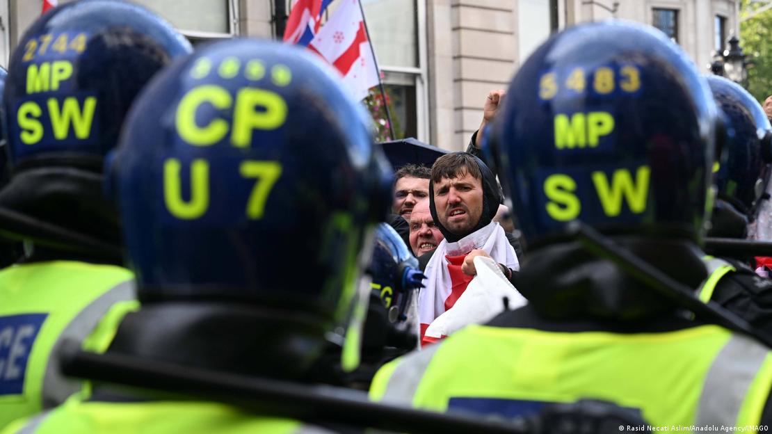 Αστυνομικοί με κράνη και διαδηλωτές Αστυνομικοί με κράνη και διαδηλωτές