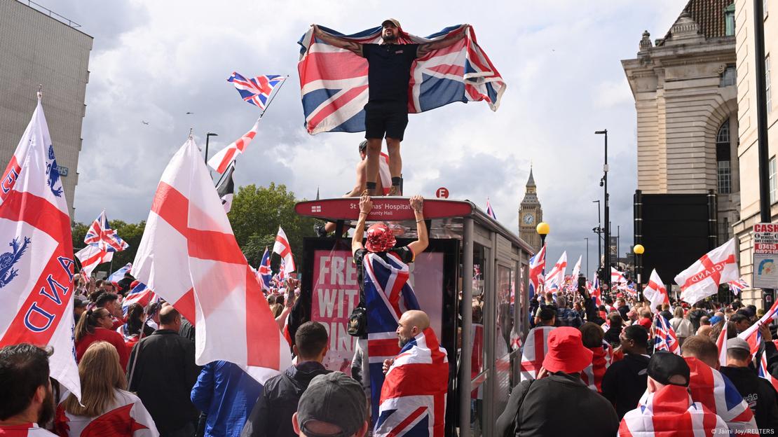 Demonstrues me flamurin britanik - Një demonstrues ngjitur në stacion autobusi me flamurin britanik