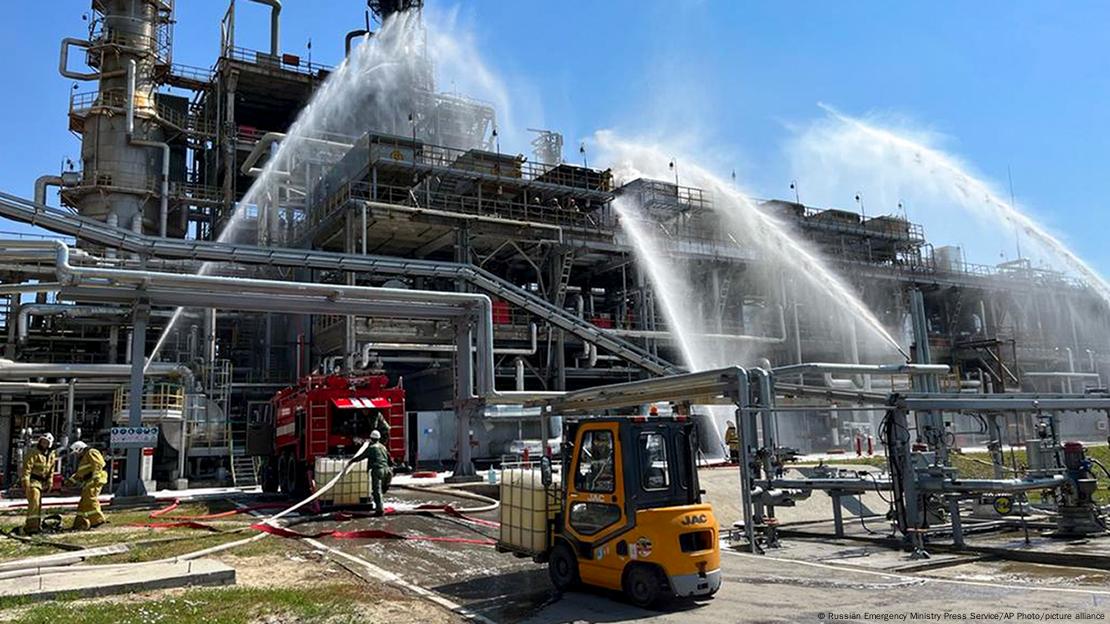 Jatos de água tentar conter fogo em refinaria