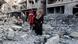 Palestinians in Gaza walk over rubble Palestinians in Gaza walk over rubble
