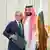 Mohammad bin Salman (right) puts his arm around Shehbaz Sharif (left), both smiling at camera
