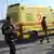 Israeli police and soldiers walk beside an Magen David Adom ambulance at the King Hussein Bridge Border Crossing, Allenby Bridge, to Jordan