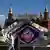 People walking in front of Intevision logo with display showing the days to go before the contest (3 when the photo was taken), Kremlin in the background
