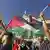 A person holds a Palestinian flag during a demonstration supporting Palestine in Lisbon, Portugal, on October 12, 2024
