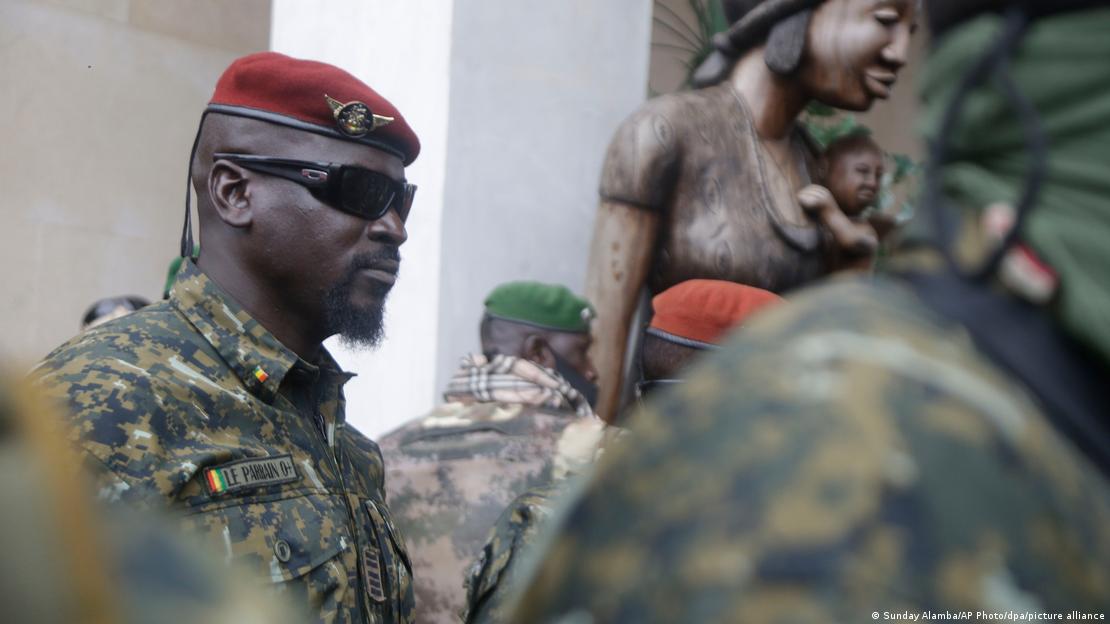 Mamady Doumbouya en treillis militaire et lunettes de soleil.