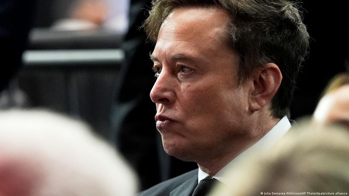Close-up of Elon Musk in three-quarter profile, pursing his lips
