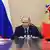 El presdiente ruso, con sendas banderas detrás a cada lado, mira directamente al objetivo de la cámara al final de una larga mesa de reuniones.