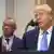 Trump speaking into a microphone at the White House, with Health Secretary Robert F. Kennedy Jr. seen blurry in the background.