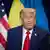 Donald Trump speaks in front of US and international flags during a press appearance