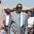 Malawi's incoming President Peter Mutharika, wearing sunglasses and a grey suit, is surrounded by a crowd of people at a polling station on September 16, 2025.