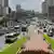 Vehicles and pedestrians pass a street in Caracas, Venezuela