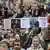 Demonstrators in a crowd hold placards depicting Slovakia's Prime Minister Robert Fico during an anti-government protest in Bratislava, Slovakia, September 23, 2025