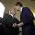 Trump and Comey shake hands in front of high-powered camera light in the White House