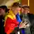 A supporter of the pro-EU Party of Action and Solidarity (PAS) draped in the Moldovan flag smiles as he checks partial results on a phone after the polls closed in the parliamentary election, Chisinau, Moldova, September 28, 2025