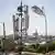 A Taliban flag flutters near telecom equipment installed over a rooftop providing internet services overlooking Hazrat-e-Ali Shrine,  on September 16, 2025.