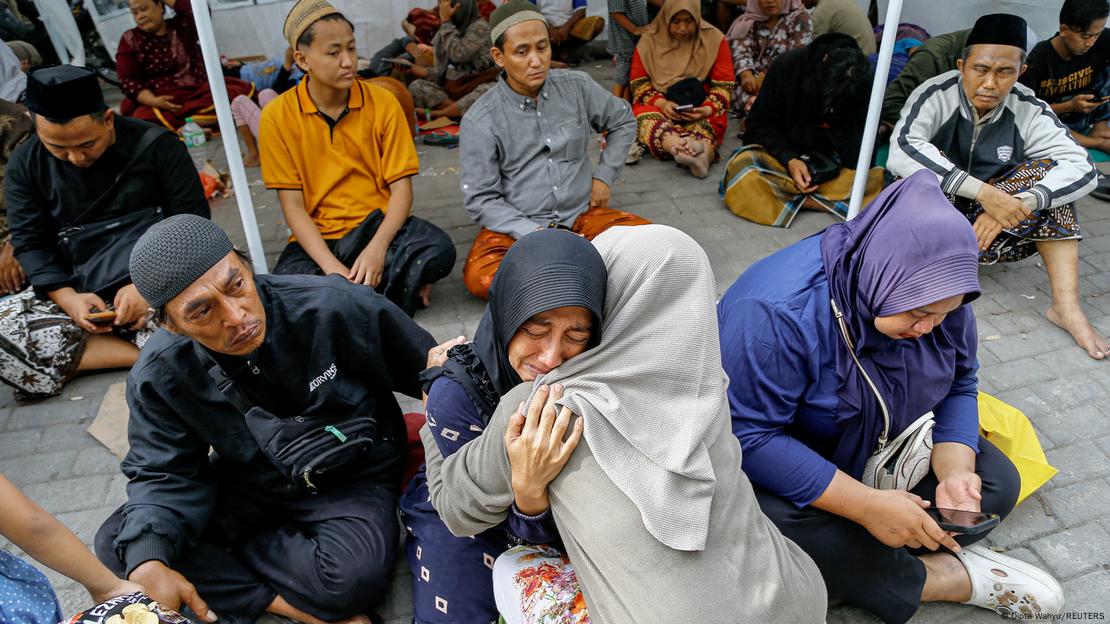 A relative of a victim of a collapsed building reacts A relative of a victim of a collapsed building reacts