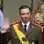 Grand Duke Guillaume looks straight ahead and raises his right hand