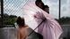 A Honduran child stands in the shade of an umbrella as she waits with her mother along the border bridge after being denied entry from Mexico into the U.S. on June 25, 2018 A Honduran child stands in the shade of an umbrella as she waits with her mother along the border bridge after being denied entry from Mexico into the U.S. on June 25, 2018