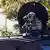 A federal officer stands guard in the Brighton Park neighborhood of Chicago, on Saturday, Oct. 4, 2025