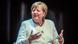 Germany's former chancellor Angela Merkel gesturing with her hands at a podium discussion Germany's former chancellor Angela Merkel gesturing with her hands at a podium discussion