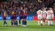 Barcelona's players celebrate a goal while, in the background, Bayern's discuss their concession Barcelona's players celebrate a goal while, in the background, Bayern's discuss their concession