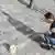 Young woman in Velbert chalks pavement, documenting the insult that she was subject to.