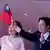 Taiwan President Lai Ching-te waves a Taiwan flag with his wife, Taiwan's first lady Wu Mei-ju, on the day he delivers a speech during National Day celebrations in Taipei
