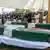Mourners stand by the coffins of slain police officials during a funeral ceremony at Dera Ismail Khan in Khyber Pakhtunkhwa province, Pakistan, on October 11, 2025