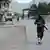 A Taliban soldier patrols near the Torkham border crossing in 2024