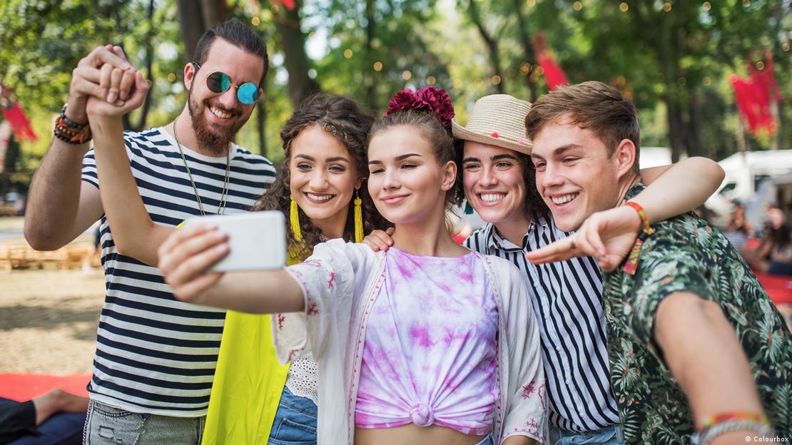 Bir grup genç kadın ve erkek özçekim yapıyor