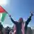A man waves a Palestinian flag in Gaza. 