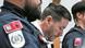 Austrian businessman Rene Benko stands between two police officers in an Innsbruck court Austrian businessman Rene Benko stands between two police officers in an Innsbruck court