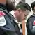 Austrian businessman Rene Benko stands between two police officers in an Innsbruck court