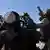 Armed Taliban security personnel watch the sky for Pakistani airstrikes during clashes between Taliban security personnel and Pakistani border forces on their shared border, photo from October 15