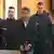 Enamullah O. with face blurred, is seen entering a German courtroom, escorted by police