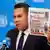 Venezuela's UN ambassador Samuel Moncada holds a newspaper