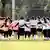 Afghanistan's female football players huddle in a circle during a training