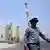 An Iranian security walks in front of the nuclear power plant in Bushehr, southern Iran on 21 August 2010